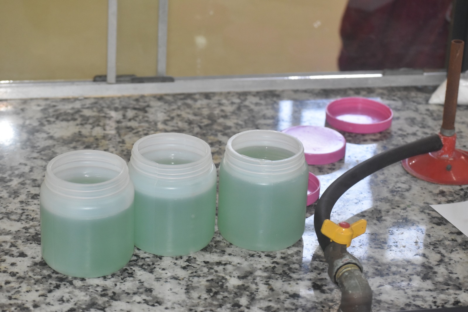 Trainees learning lotion and cosmetics formulation in a workshop